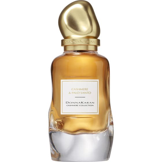 DKNY Cashmere Collection Palo Santo 100 ml Eau de Parfum med bärnstensfärgad vätska i vågig glasflaska med guldlock