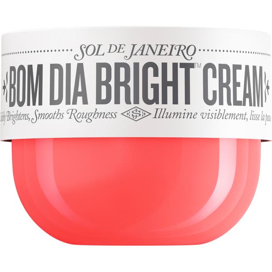 Sol de Janeiro Bom Dia Bright Cream lystergivande kroppskräm med AHA och C-vitamin i en korallrosa burk med vitt lock.