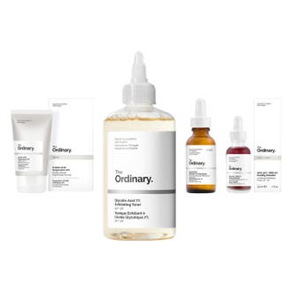 The Ordinary hudvårdsset 4 delar ger lyster med exfolierande syror i vit tub och glasflaskor med pipetter.