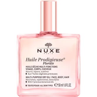 Nuxe Huile Prodigieuse Florale 50 ml torrolja som ger näring i en rosa glasflaska med glänsande roséguldfärgad kork