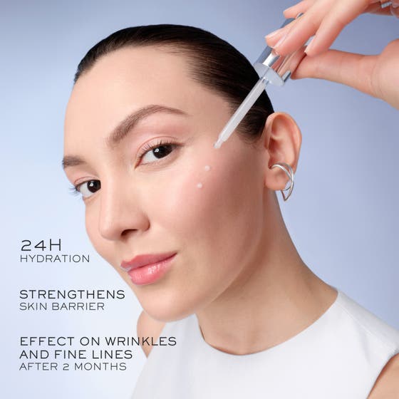 Lancôme Génifique Ultimate Serum 50 ml anti age hudvård med dropper som skapar en klar droppe mot en lysande blå sfär