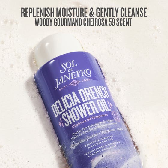 Sol de Janeiro Delicia Drench Shower Oil 385 ml närande duscholja i lila flaska omgiven av vitt lödder och gyllene olja