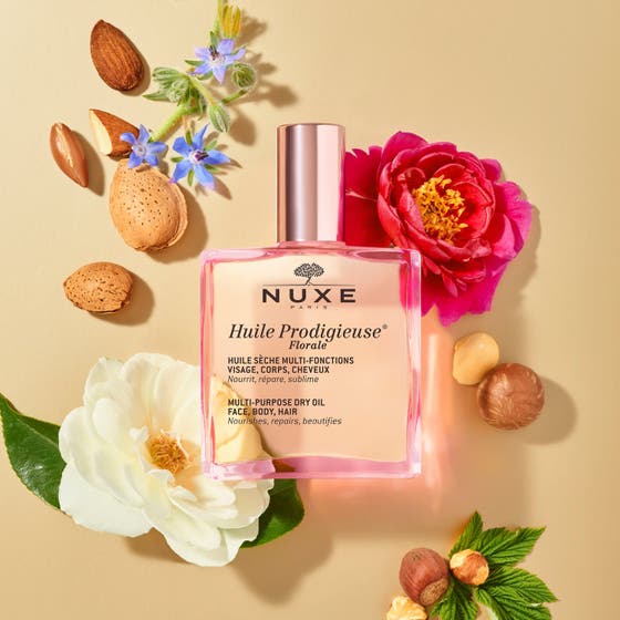 Nuxe Huile Prodigieuse Floral 100 ml närande ansiktsolja torr hud i glasflaska intill matchande parfym och duschgel.