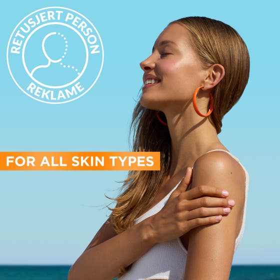 Garnier Ambre Solaire Hydra 24H Protect 175 ml återfuktande solskydd på kvinna med lyster i solljus