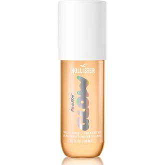 Hollister Body Mist Feelin' Glow 198 ml uppfriskande body mist i persikofärgad flaska med vitt lock och holografisk text