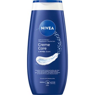 Nivea Creme Care 250 ml fuktgivande duschkräm för torr hud i en mörkblå flaska med krämig vit textur