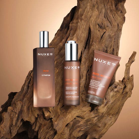 Nuxe Men Multi Action Serum 30 ml ger huden energi i en brun glasflaska med silverkork och orange detaljer.