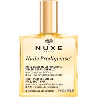 Nuxe Huile Prodigieuse 100 ml dry oil ger näring i en fyrkantig glasflaska med glansig guldkork.
